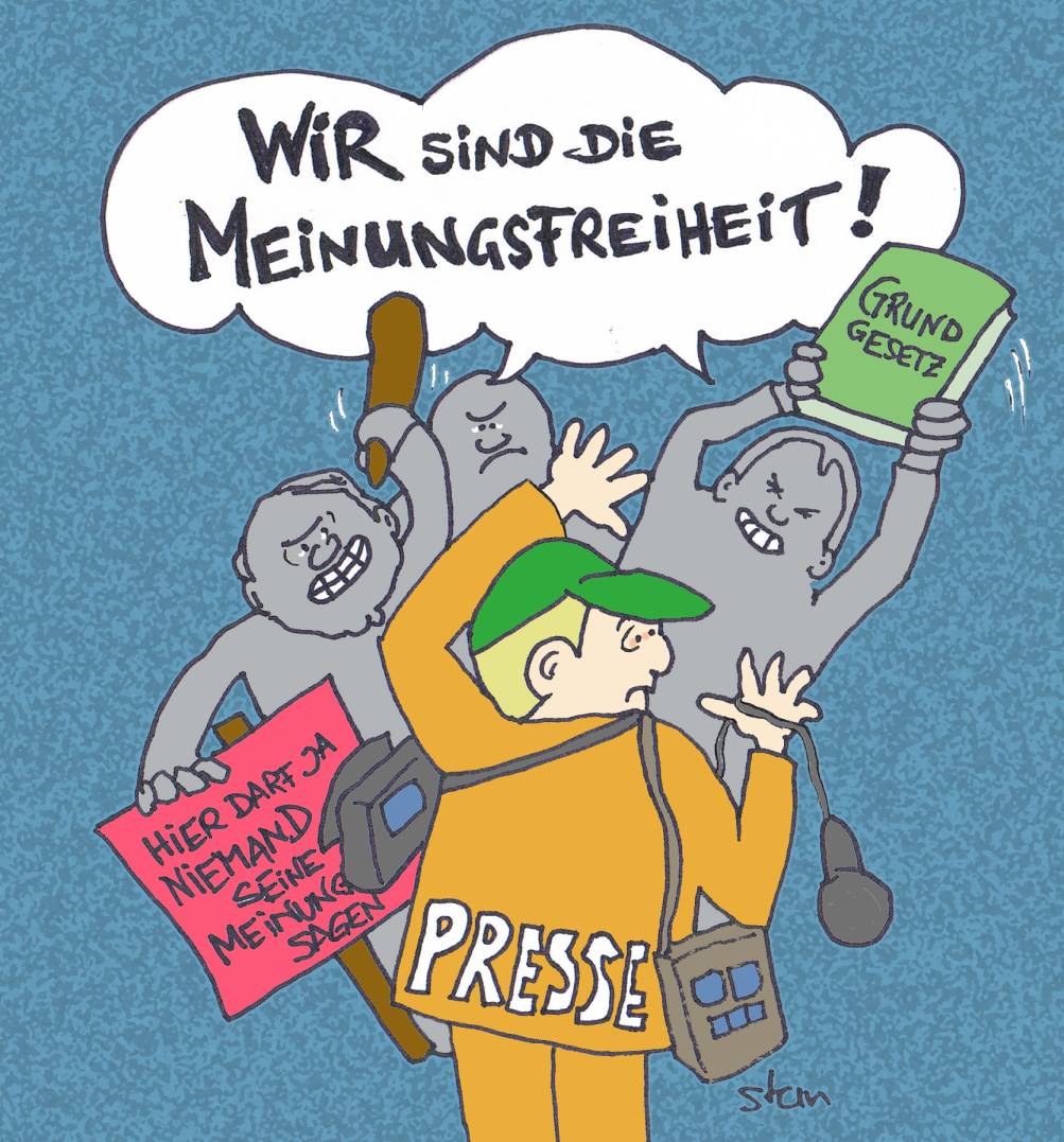 – Meinungsfreiheit mit dem Grundgesetz fest in der Hand. Karikatur: Karlheinz Stannies